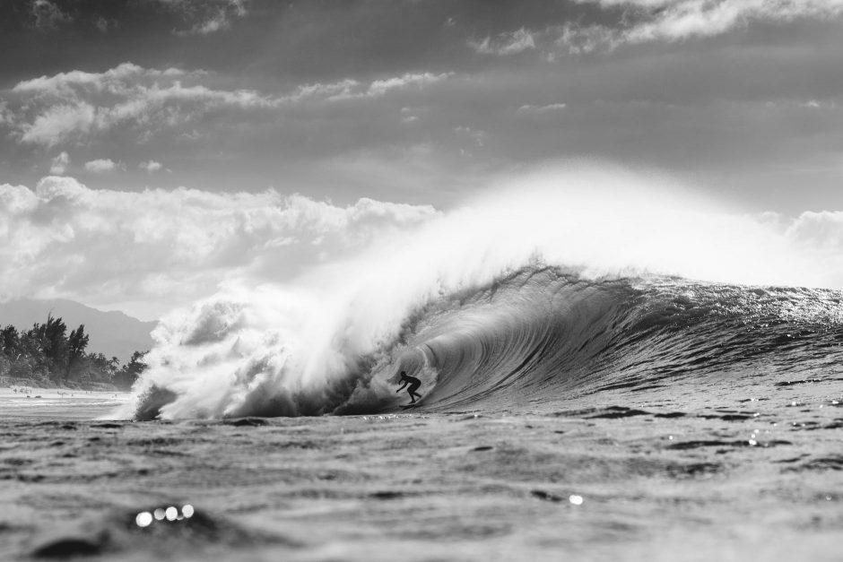 unrecognizable surfer in wavy sea