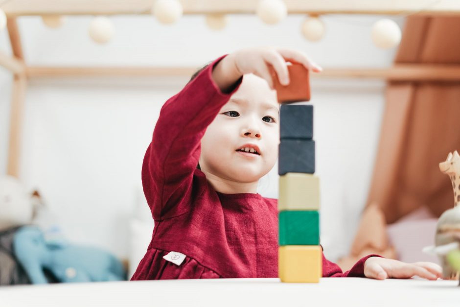 child playing wooden blocks